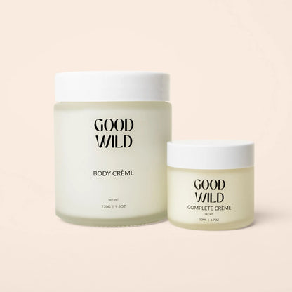 Two jars of 'Good Wild' body and complete crème on a light pink background