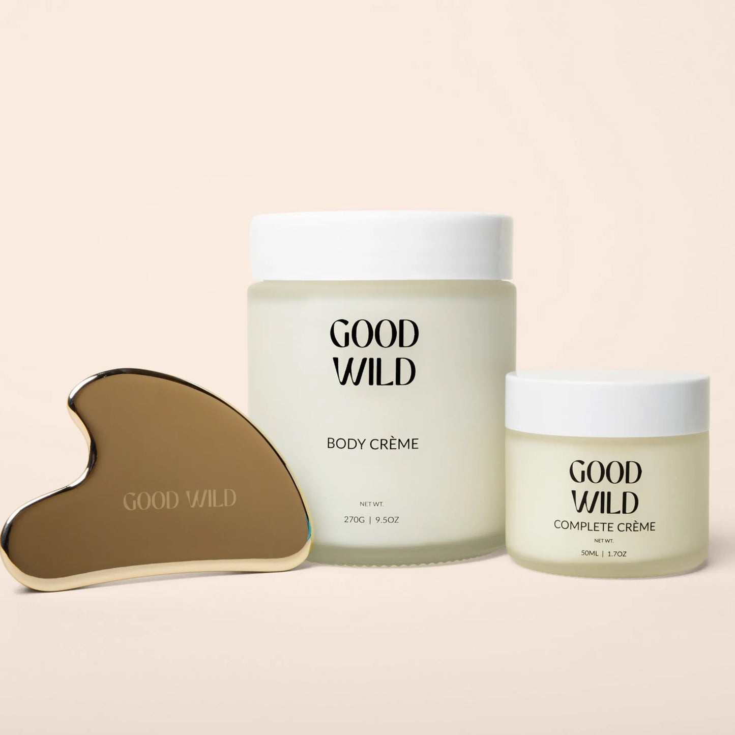 Two jars of 'Good Wild' body and complete crème with a gua sha tool on a beige background
